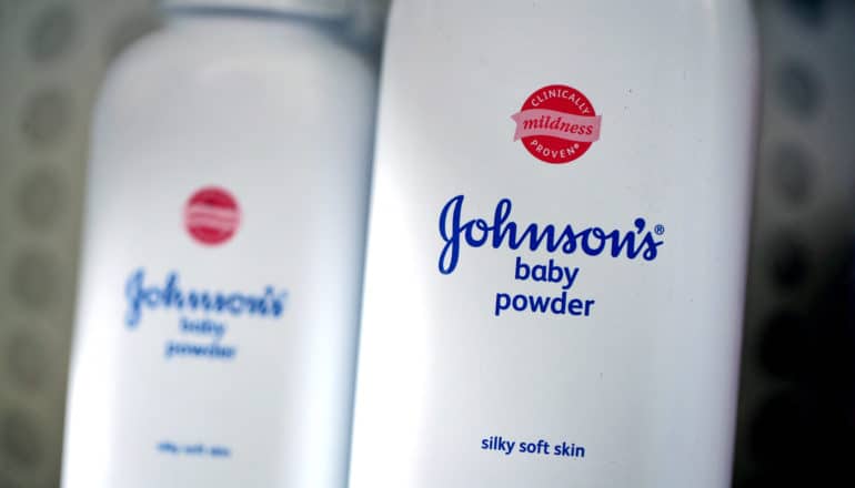 two containers of baby powder on shelf