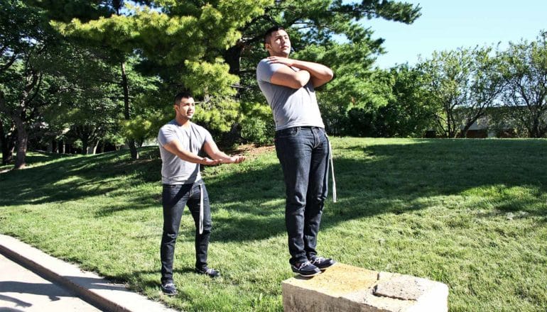 A man does a trust fall with another photo of himself