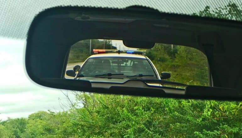 police car in rear-view mirror