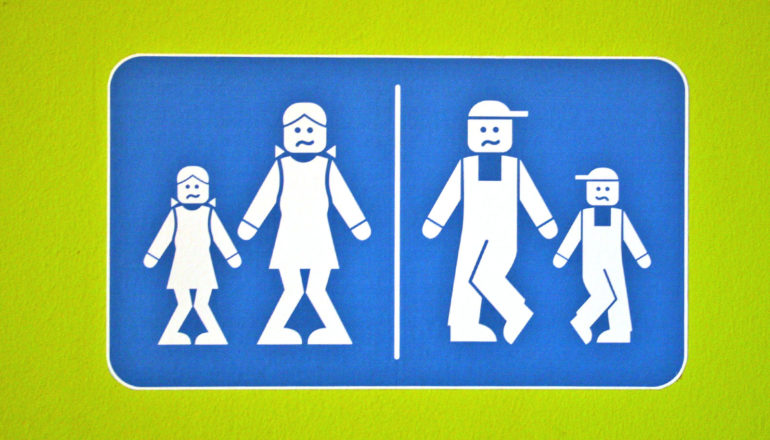 bathroom sign depicts figures who need to pee