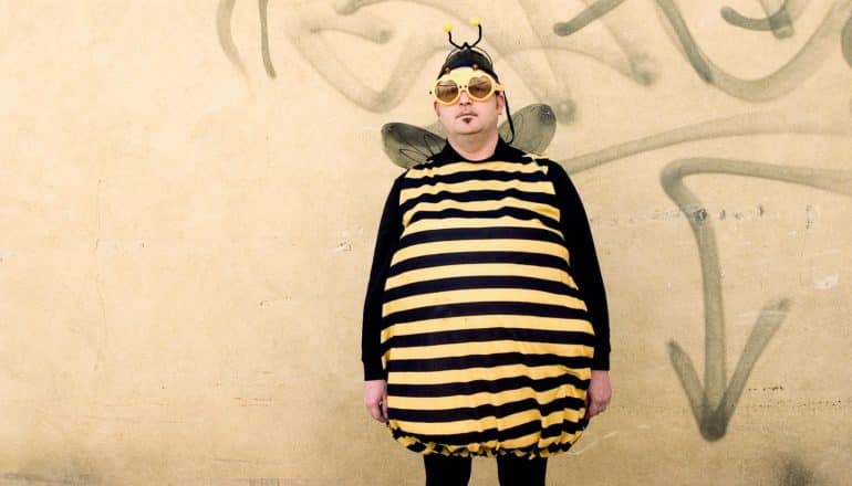 serious adult in bee costume