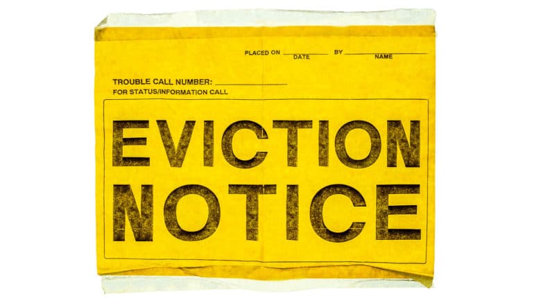 worn yellow paper says "eviction notice" in big black letters