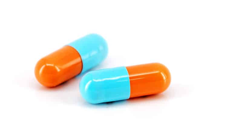 two orange and blue capsules