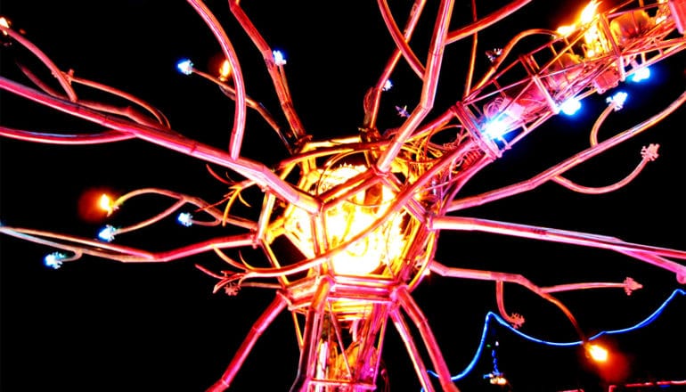 A sculpture looks like a neuron, with a lighted center and many tendrils coming out of it with lights on them