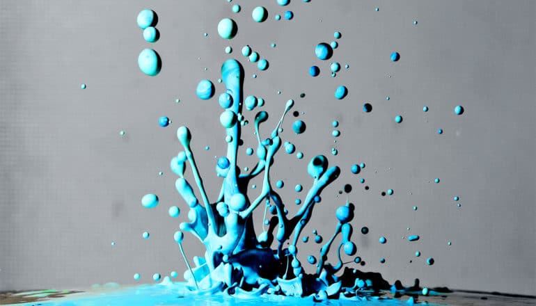 Blue paint splashes against a gray background