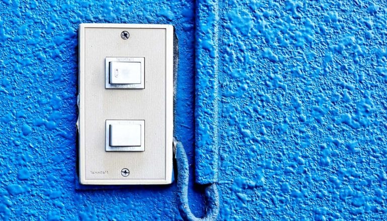 A switch on a bright blue wall