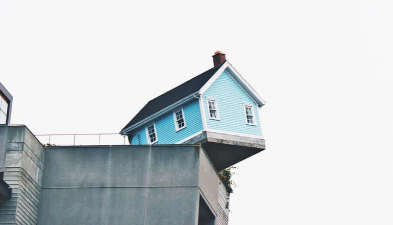 house on edge of cement wall