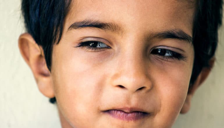 thoughtful child looks to the side