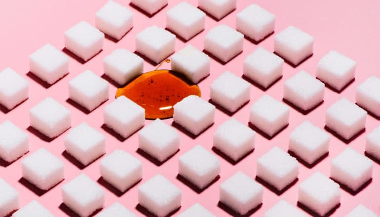 blob of honey in grid of sugar cubes