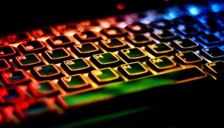 A keyboard glows in red, orange, blue, and green light