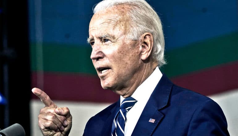 Joe Biden speaks while pointing his finger towards the audience