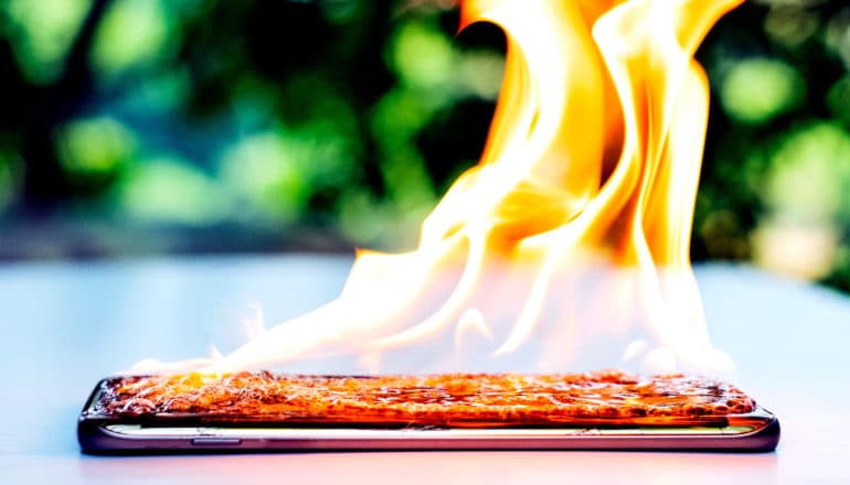 A flaming phone on a table outside