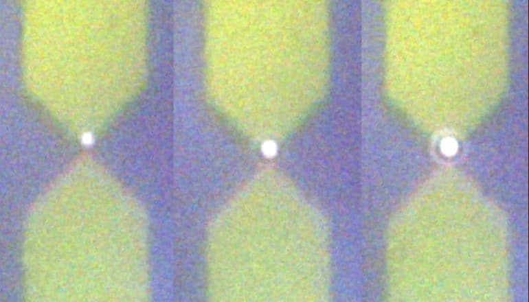 three pairs of pointed columns meet in the center. Dot of light where they meet