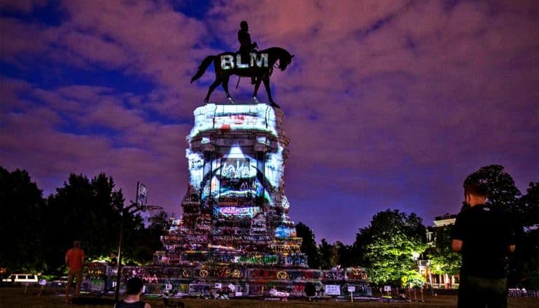 George Floyd's face appears on the monument's base, while the letters "BLM" appear on the Robert E. Lee's horse