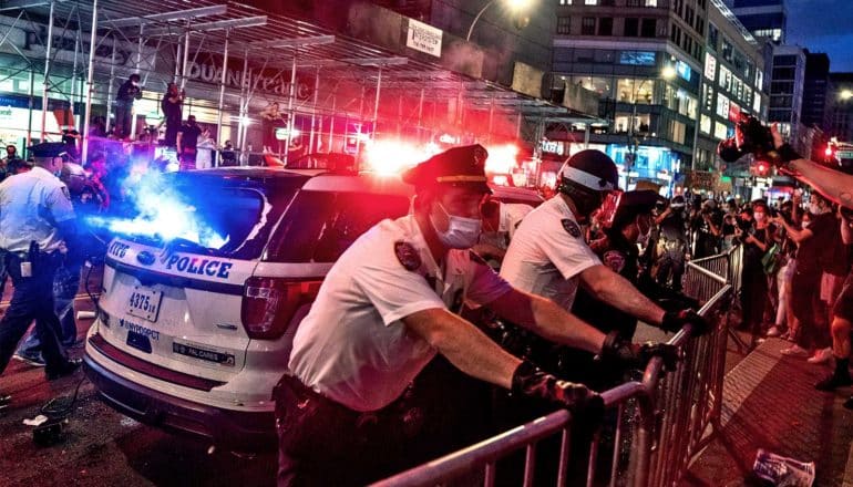 Police hold a barricade against protesters lining streets in New York City