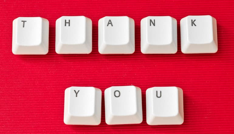 Computer keys spell out "Thank You" on a red background