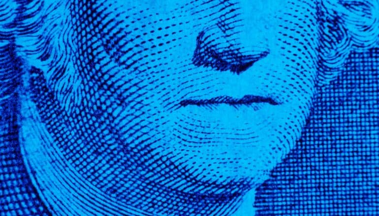 Washington's closed mouth on dollar bill -- blue filter