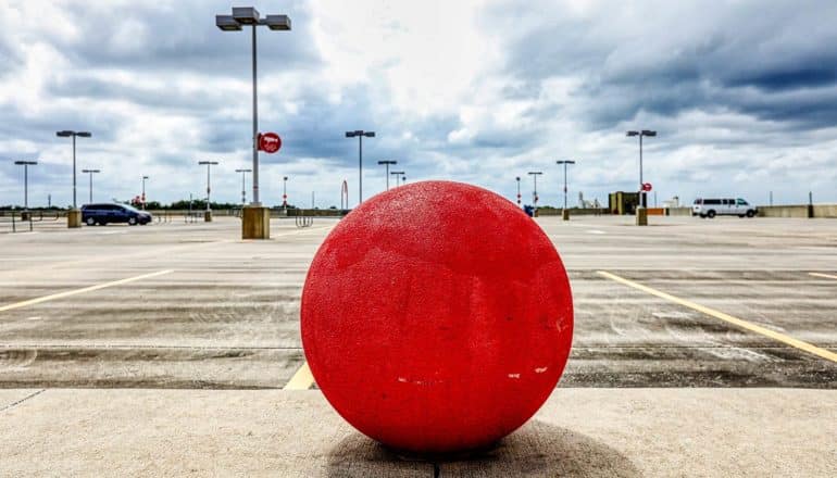 empty parking lot with red concrete ball