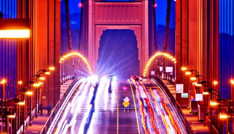 Cars driving on the golden gate bridge at night