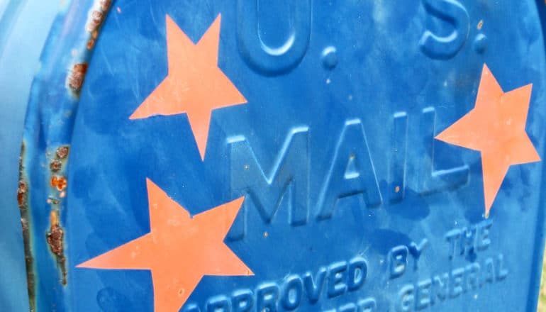 A blue US mailbox has three red stars on it