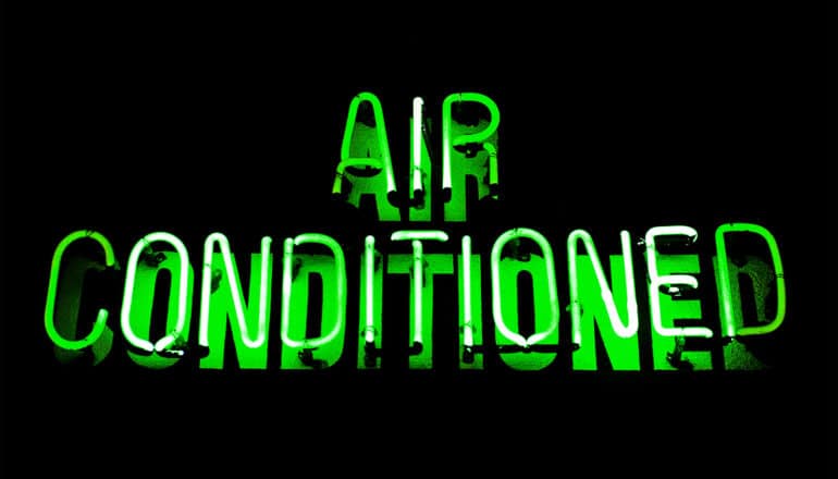 A green neon sign reads "Air Conditioned"