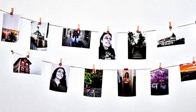 Photos hang on string on a wall