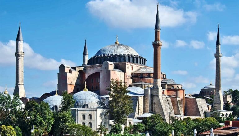 The Hagia Sophia, with its minarets and large central dome, stands against a blue sky