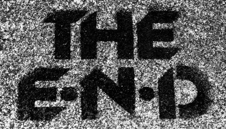 Painted text on asphalt reads "The End"