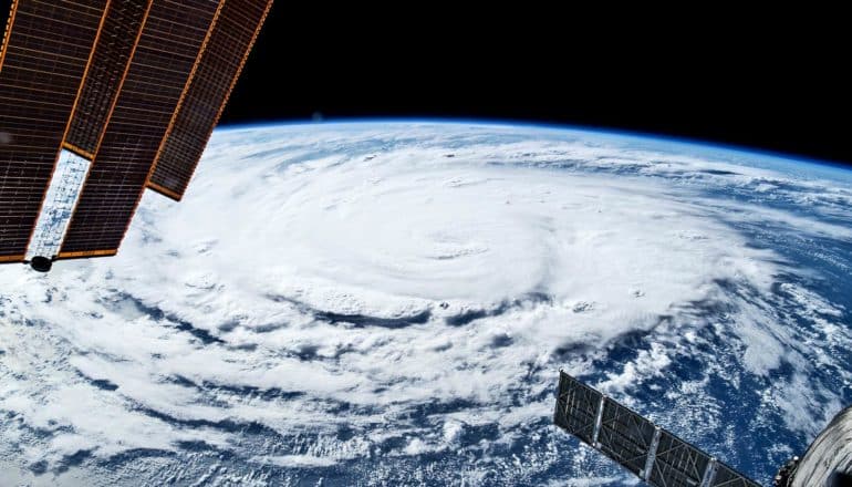 A hurricane swirls on Earth's surface as seen from space