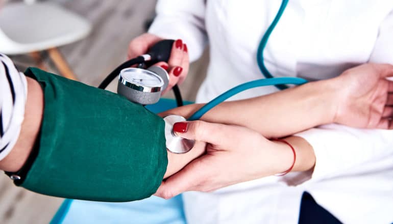 A doctor takes a patient's blood pressure