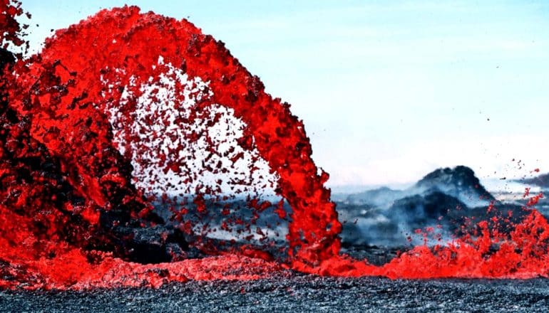 Bright red magma pours from a volcano