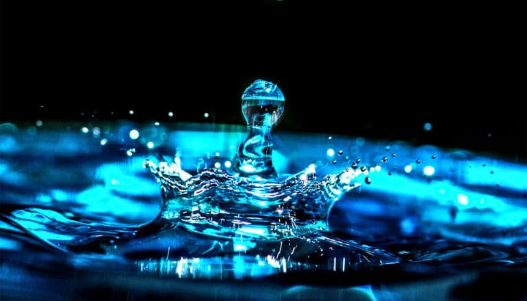 A droplet of water creates ripples as it splashes down