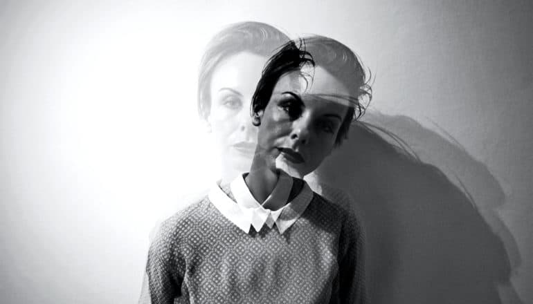 Double exposure shows a woman in two places at once