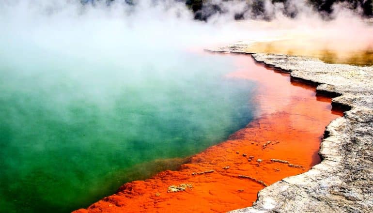 A green and orange hot spring