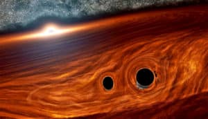 Two black holes sit side by side in an orange-colored swirl near a larger black hole surrounded by light