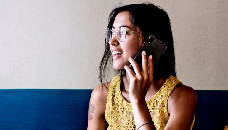 A young woman talks on the phone