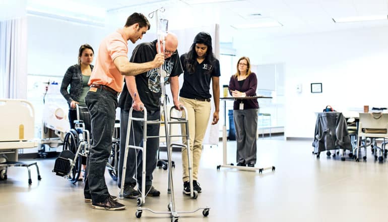 A patient uses a walker during physical therapy