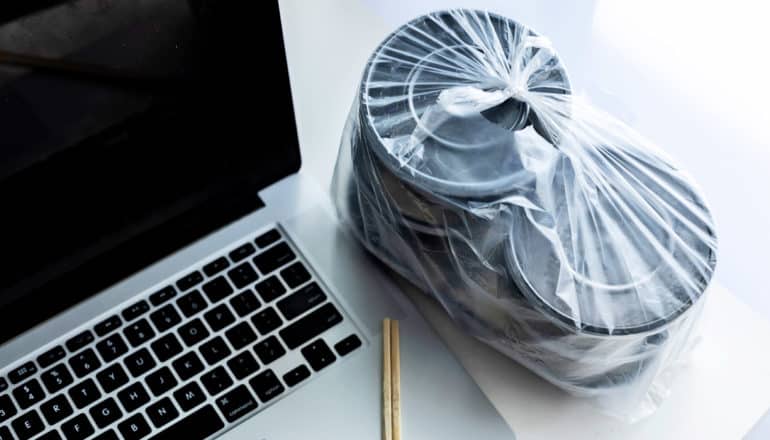 plastic take-out containers and laptop