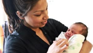 A mom holds a newborn baby