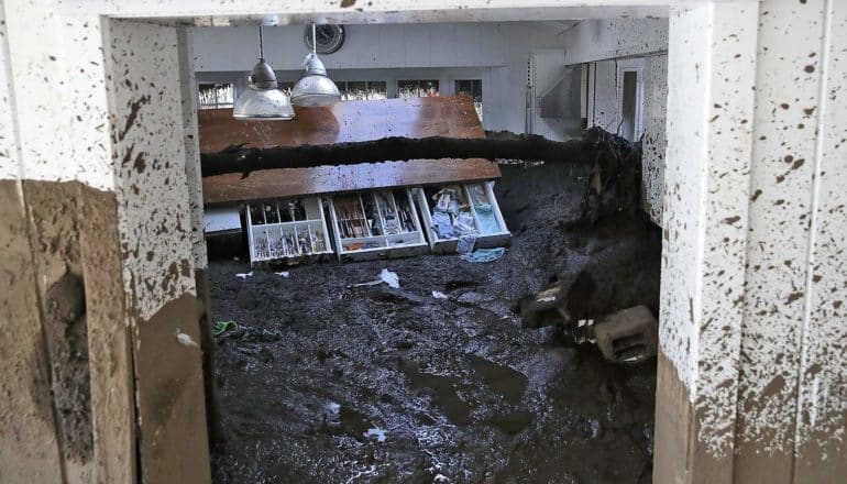 drawers fall from cracked counter in kitchen full of mud