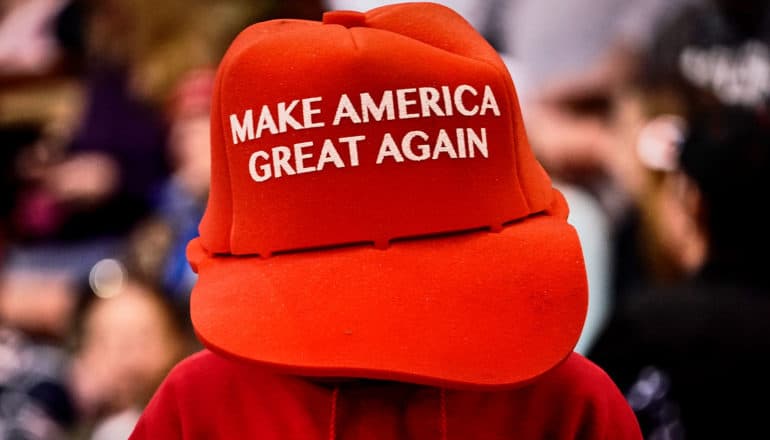 person in giant MAGA hat