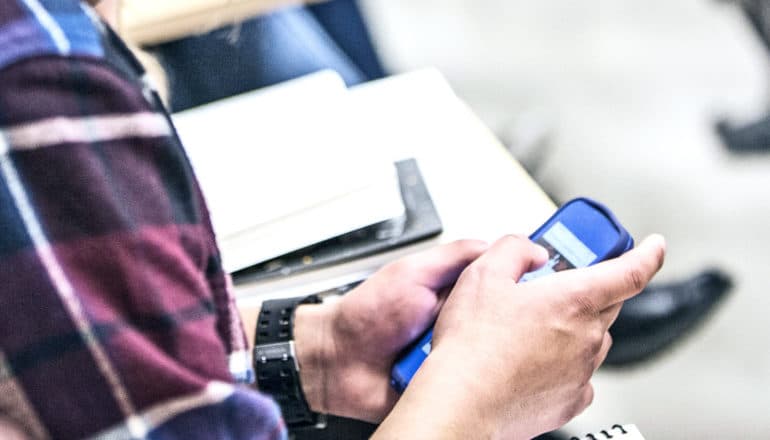 A student use their smartphone in class