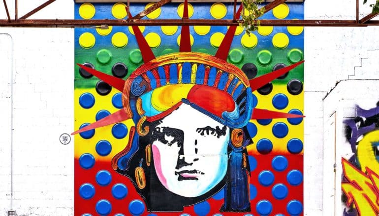 A colorful painting of the Statue of Liberty's face on a wall
