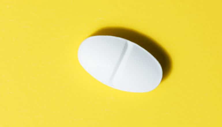 white pill on yellow background