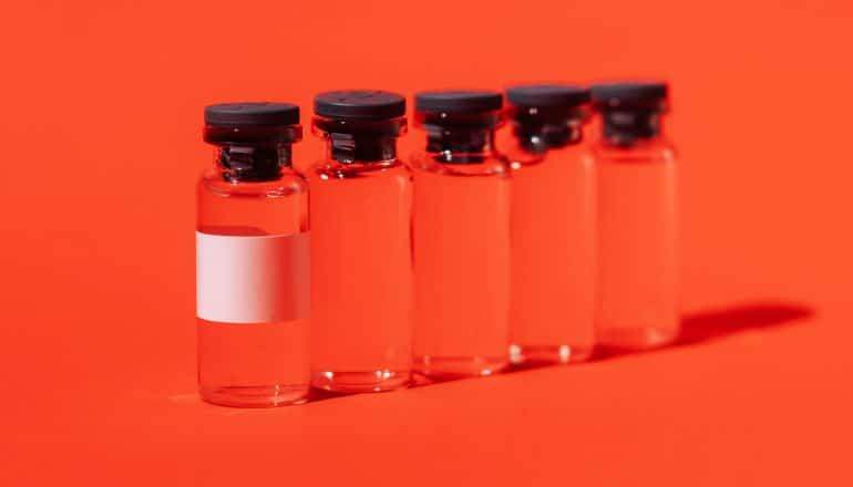 line of vials on red background