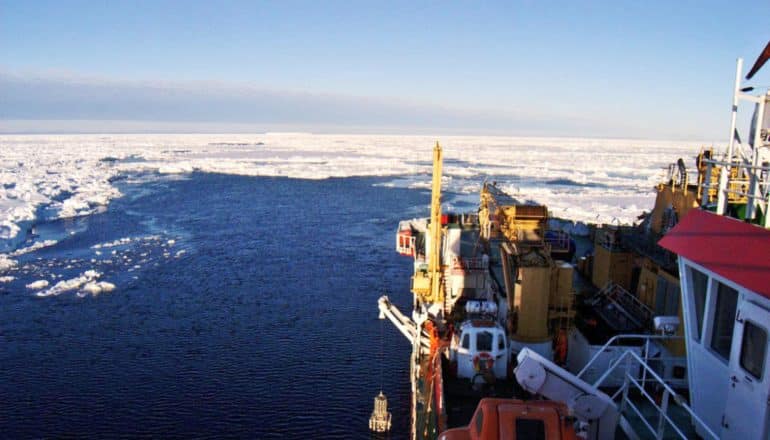 ship approaches open water amid sea ice