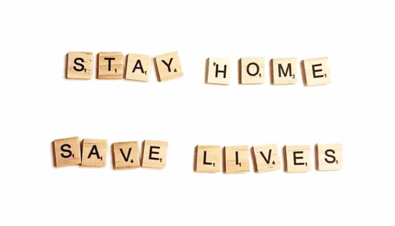 scrabble tiles spell "stay home save lives"