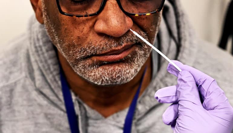 A man gets a COVID-19 test via nasal swab