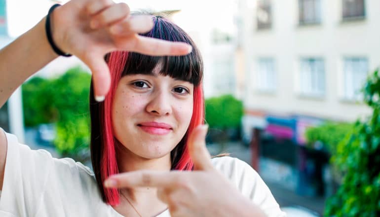 person frames hands with fingers