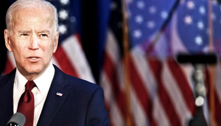 Biden speaks in front of American flags